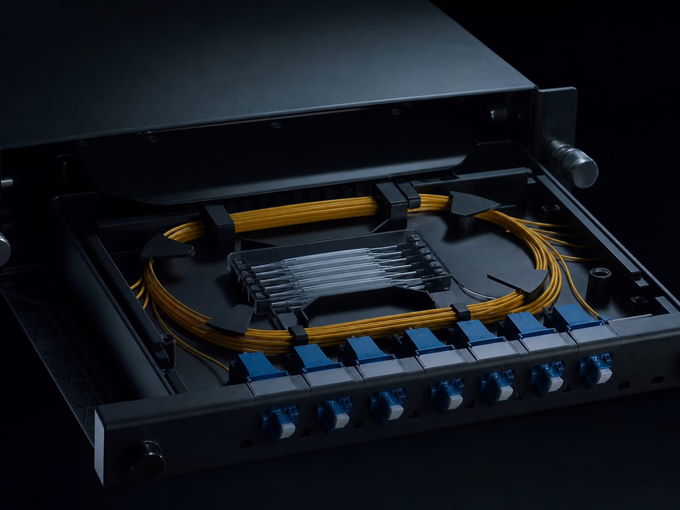 Fibre splice tray with coiled strands and labelled patch leads